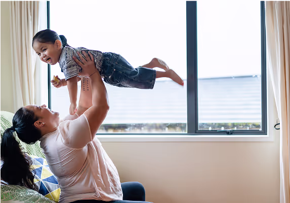 A woman is holding a child in her arms.