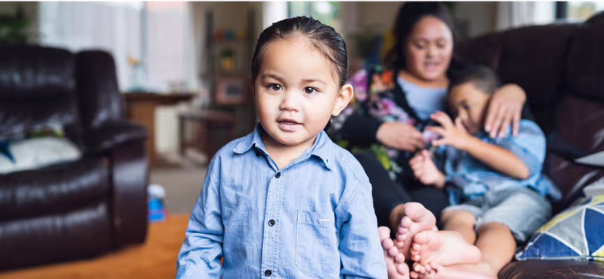 A young boy wearing a blue shirt and blue jeans.
