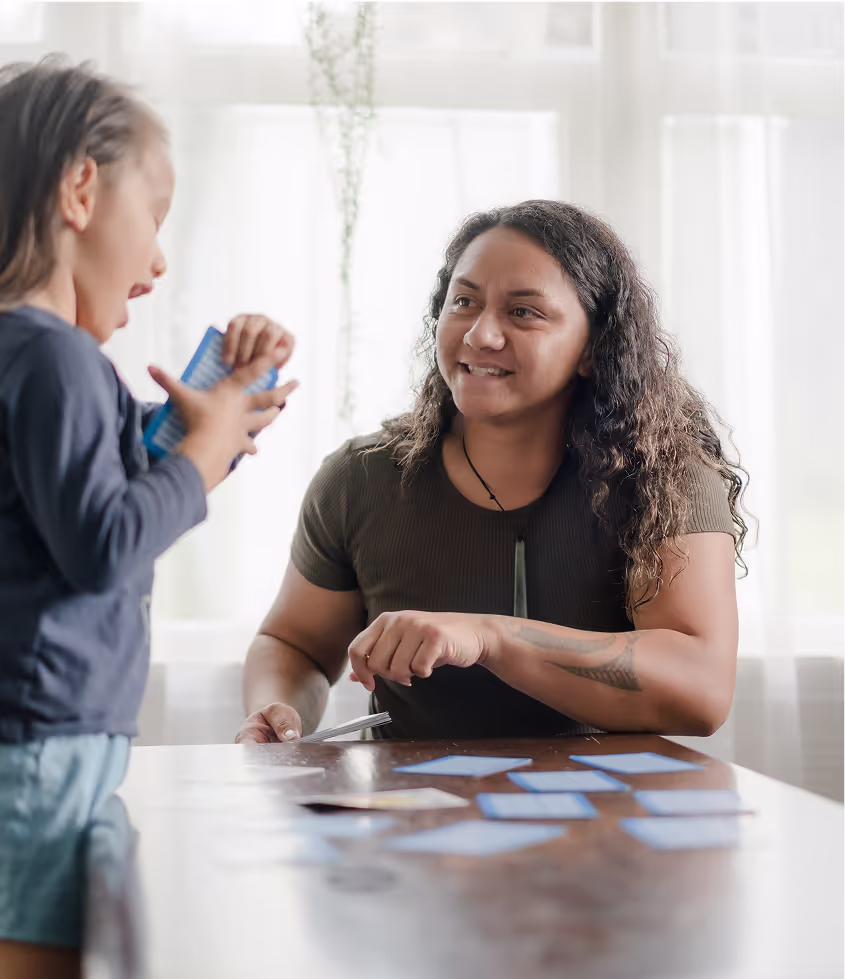 A woman and a child are playing a game together.