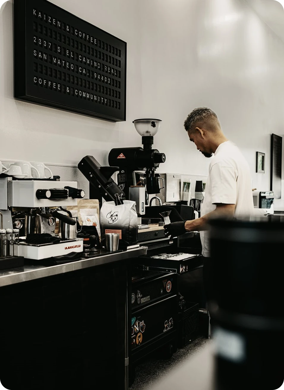 Man working behind a coffee bar.