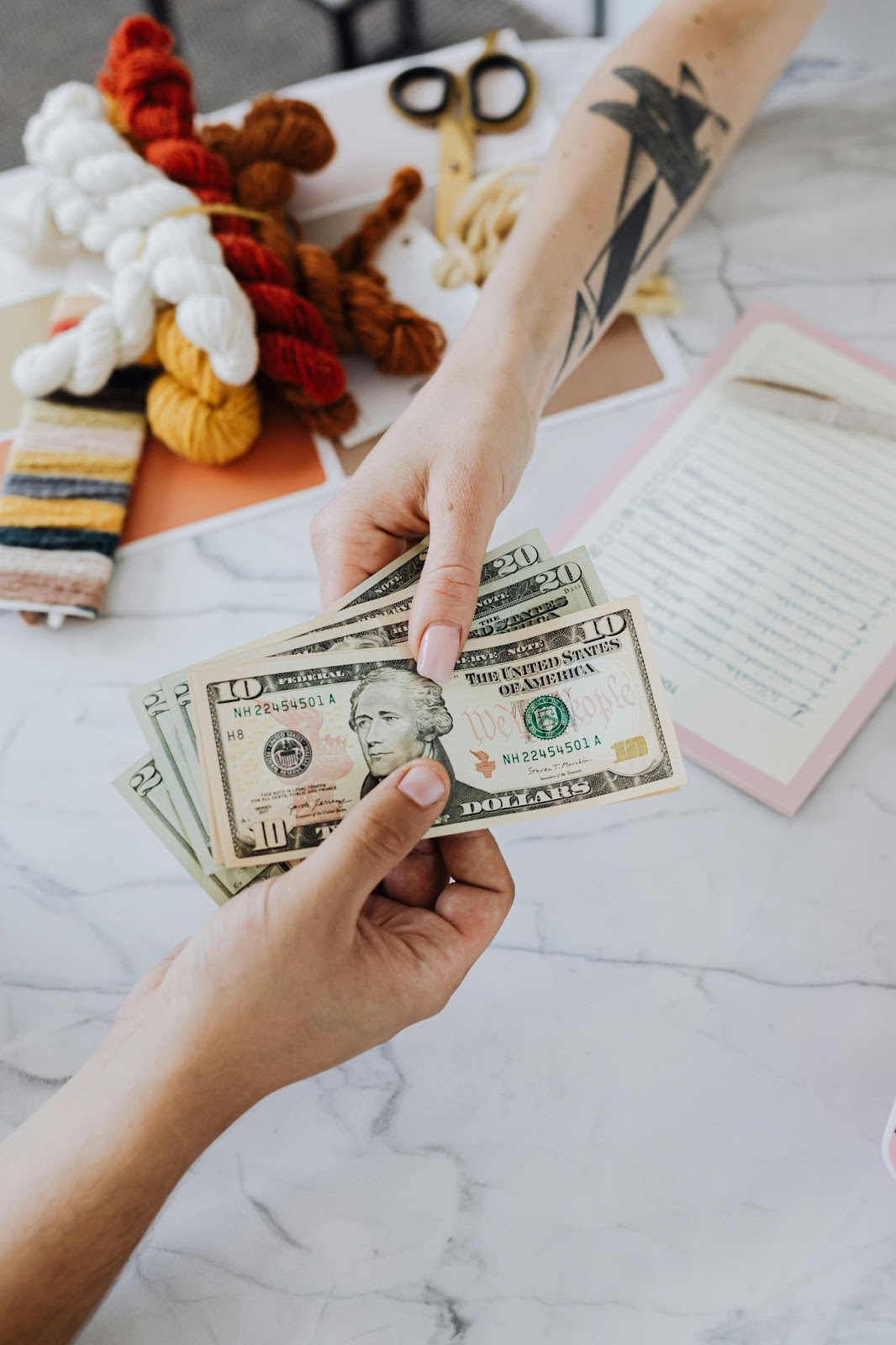  person giving money to someone else