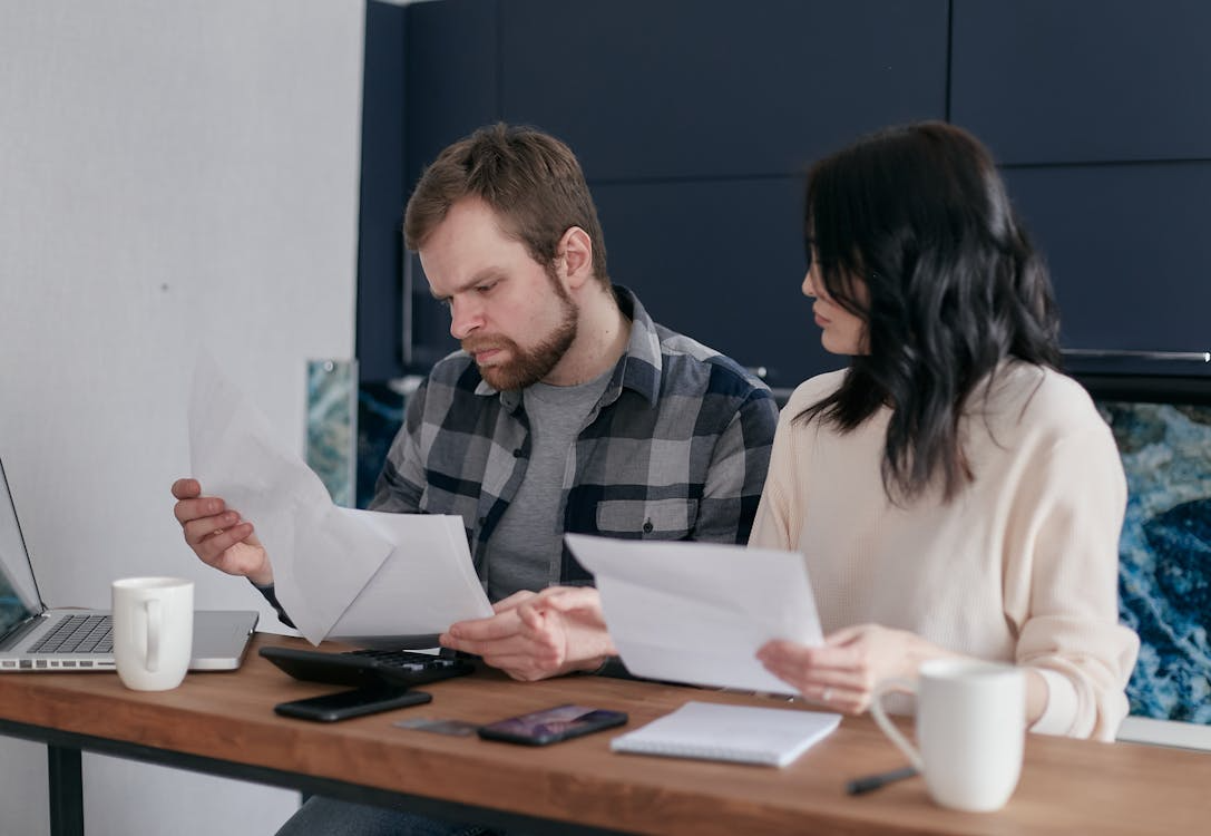  couple reviewing finances and documents for a mortgage applicatio