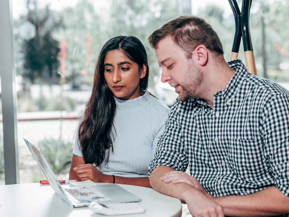  couple reviewing housing documents and monthly expenses at home