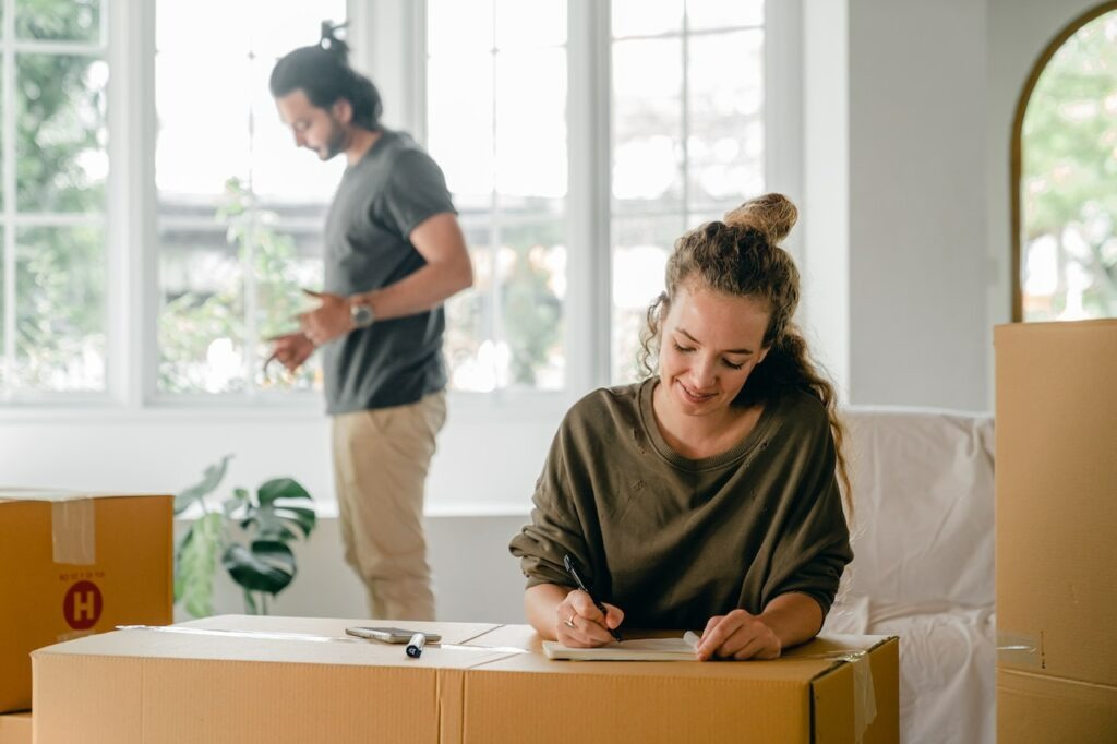 a happy couple writing in a notepad