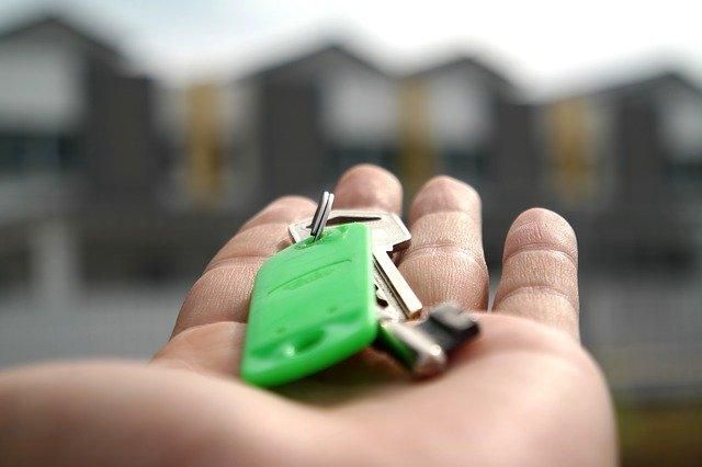 a hand holding a house key