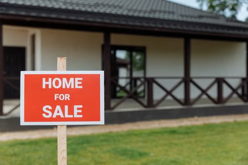 Home with a sold sign in the front yard.