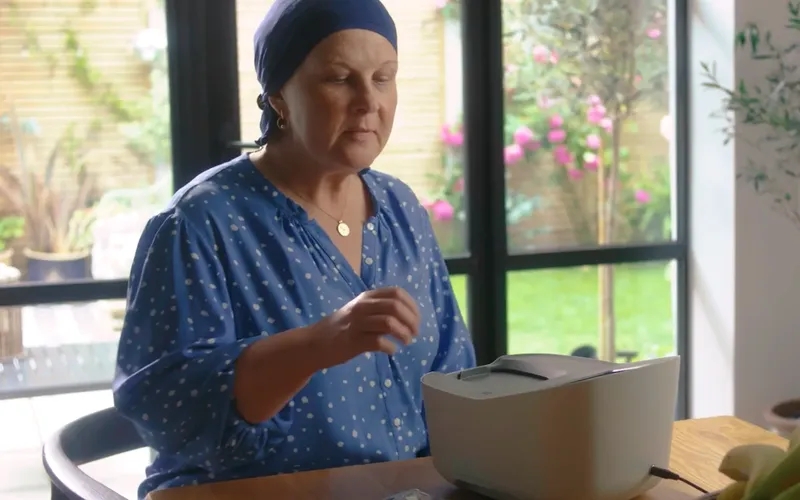 A patient using the Entia at-home blood monitoring device