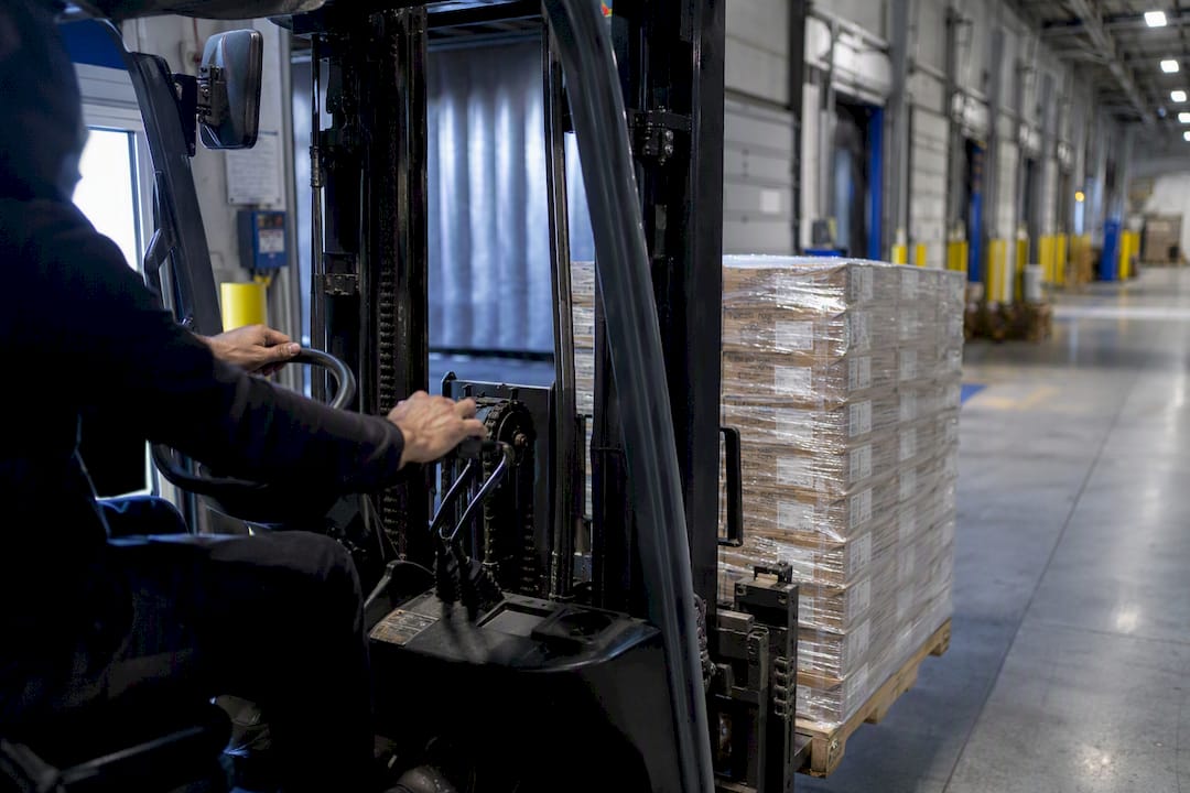 Forklift moving pallet at event venue dock