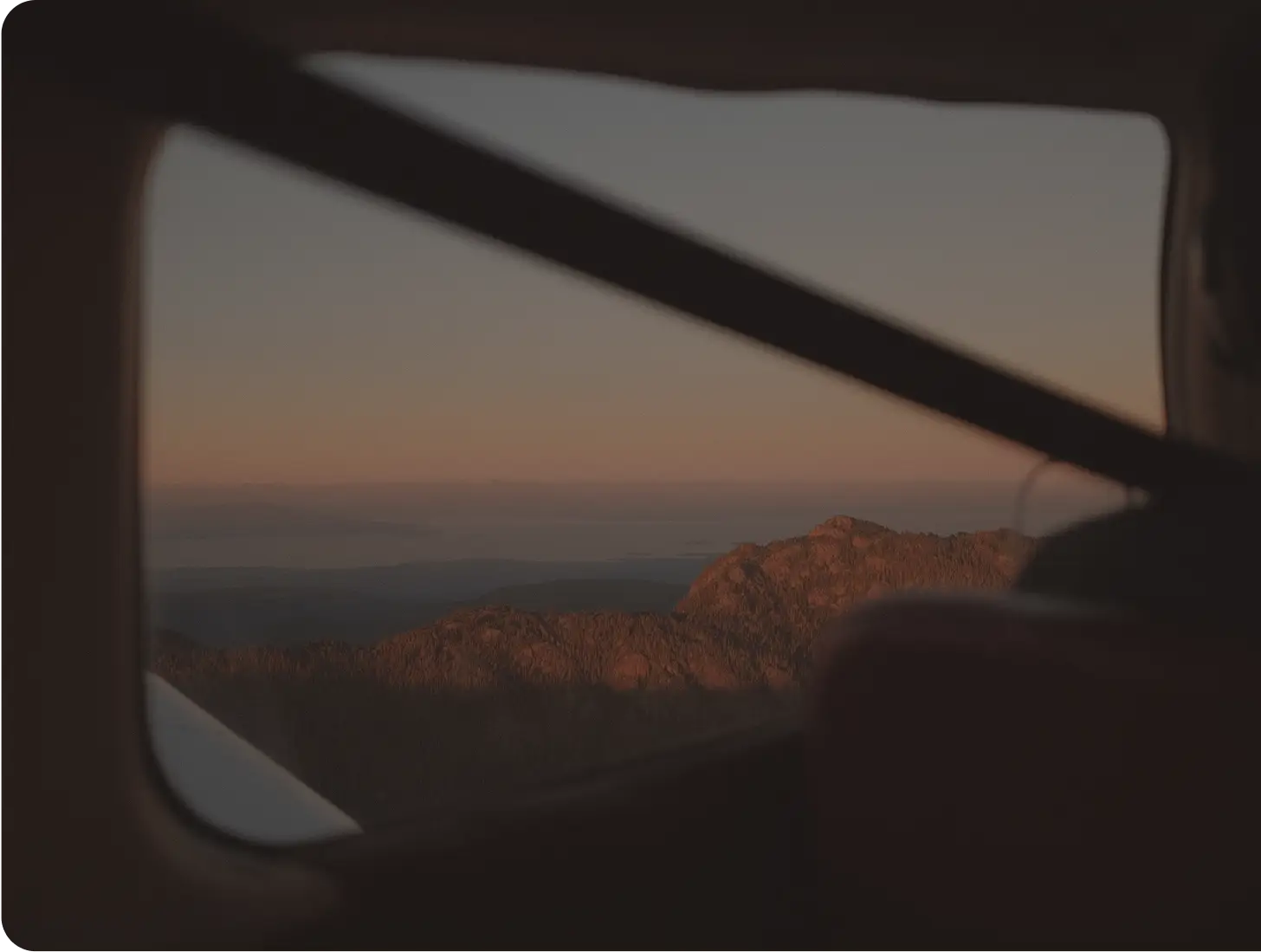 Rocky mountain landscape viewed through an aircraft window