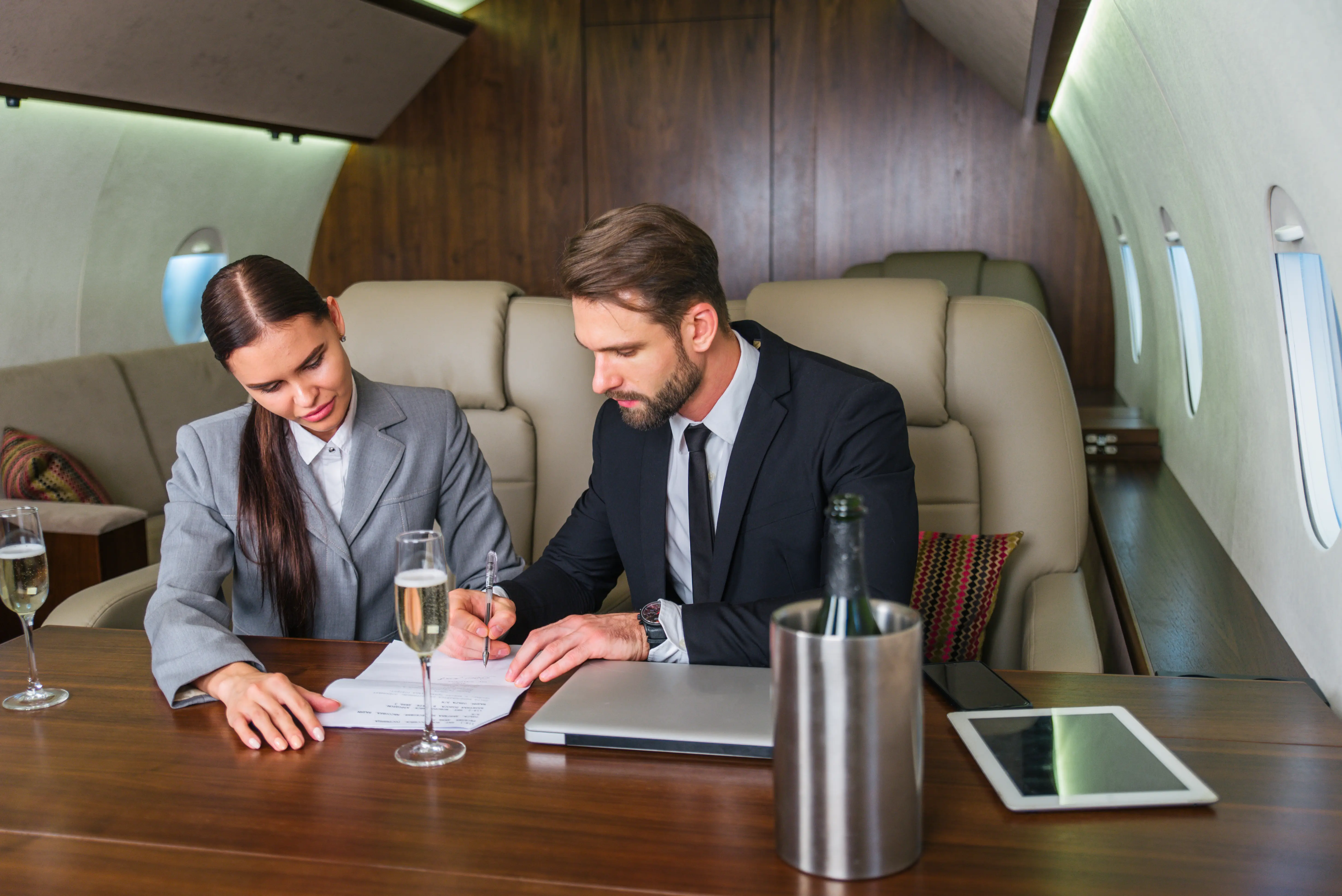 Business professionals working together on a document in a private jet