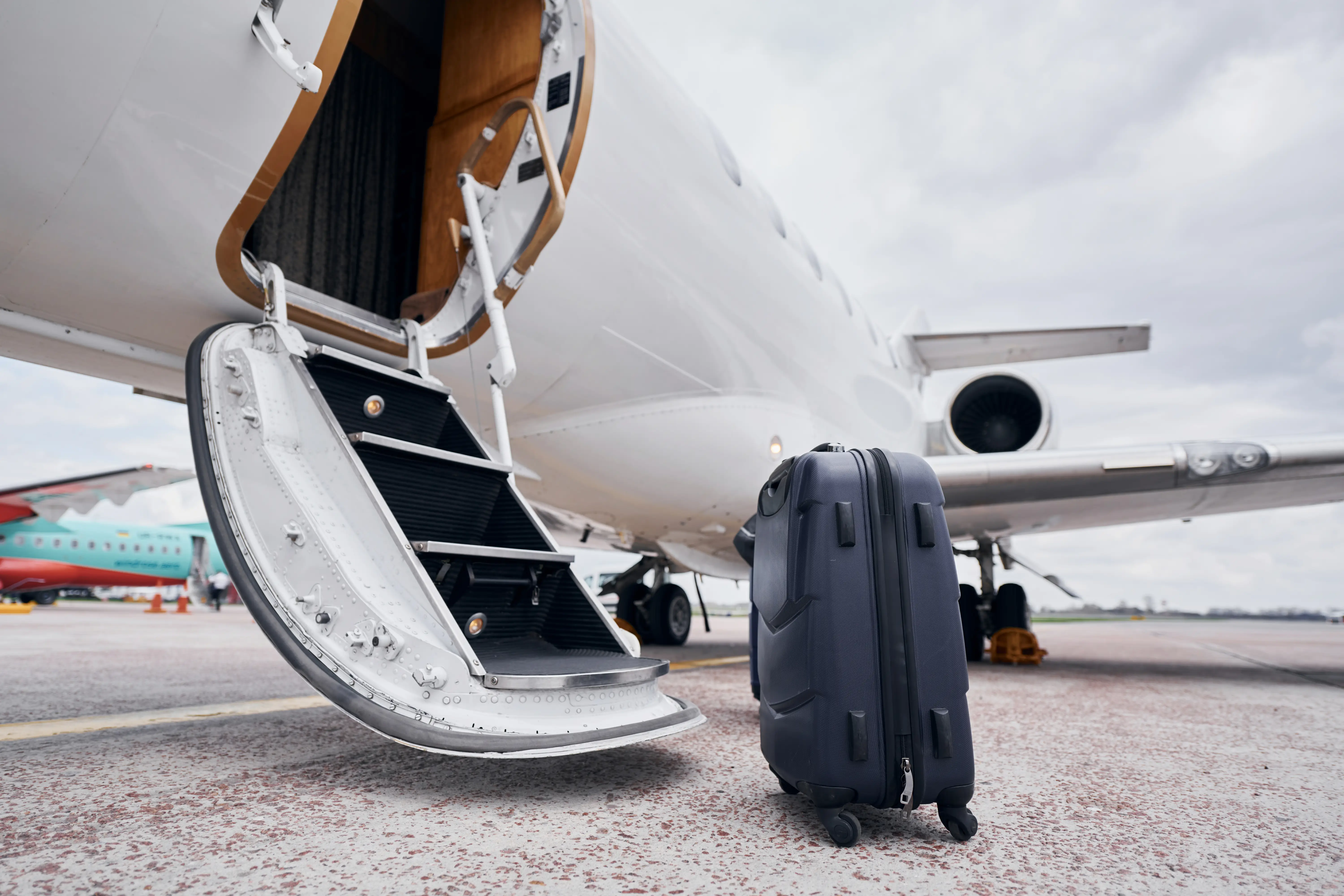 Airplane boarding stairs with luggage, ready for passenger departure