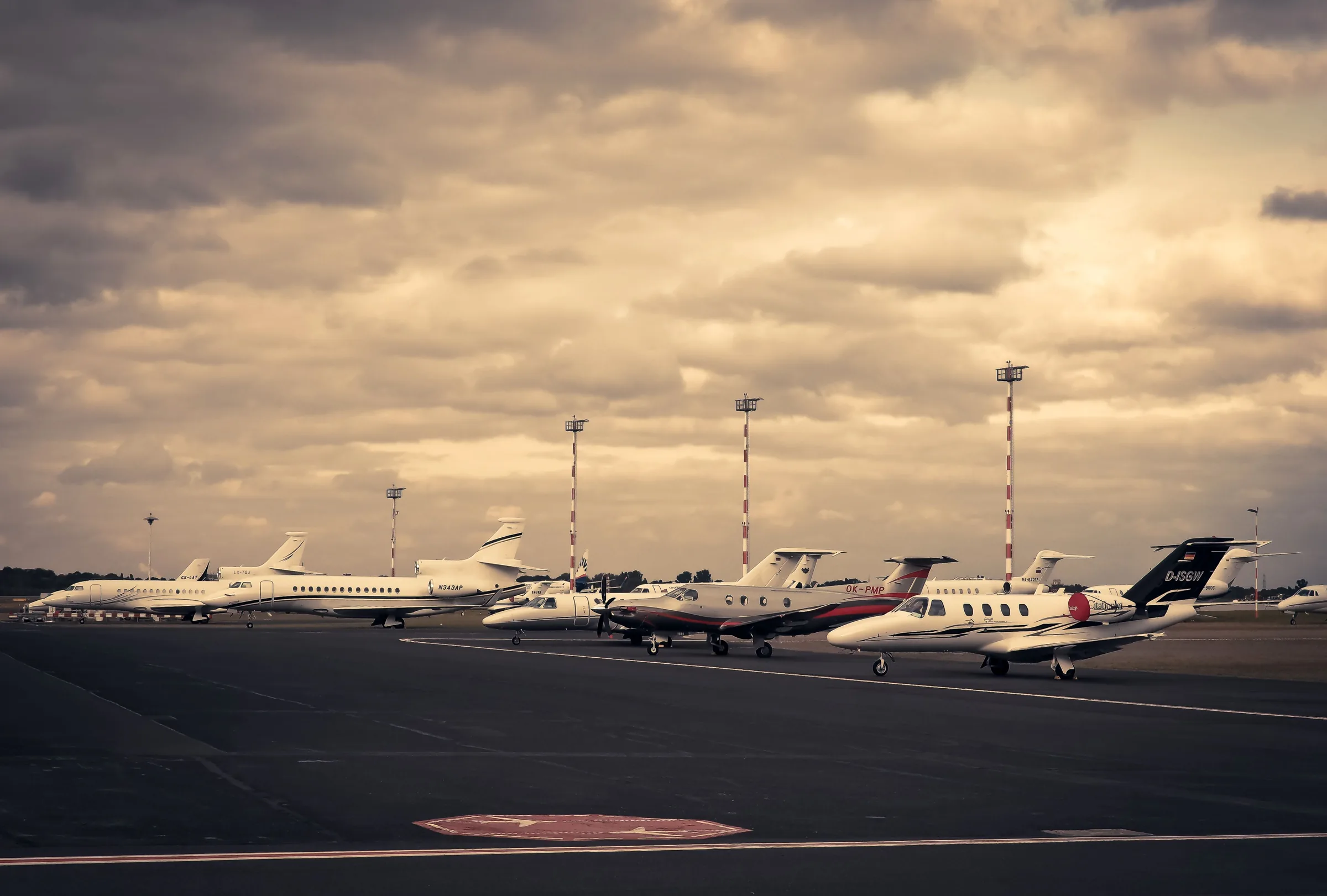 Private jets parked on an airport apron