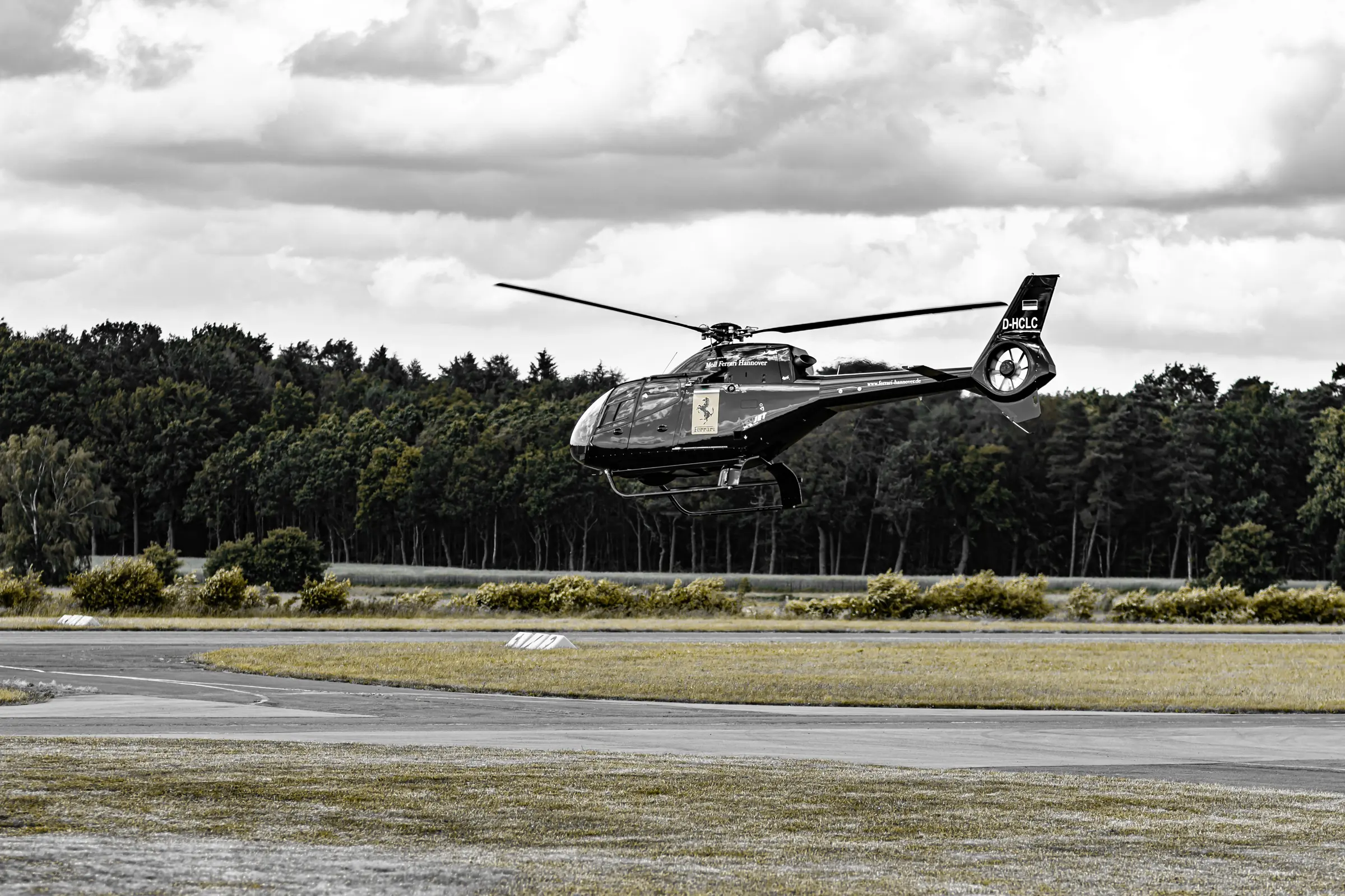 Helicopter lifting off from an airfield