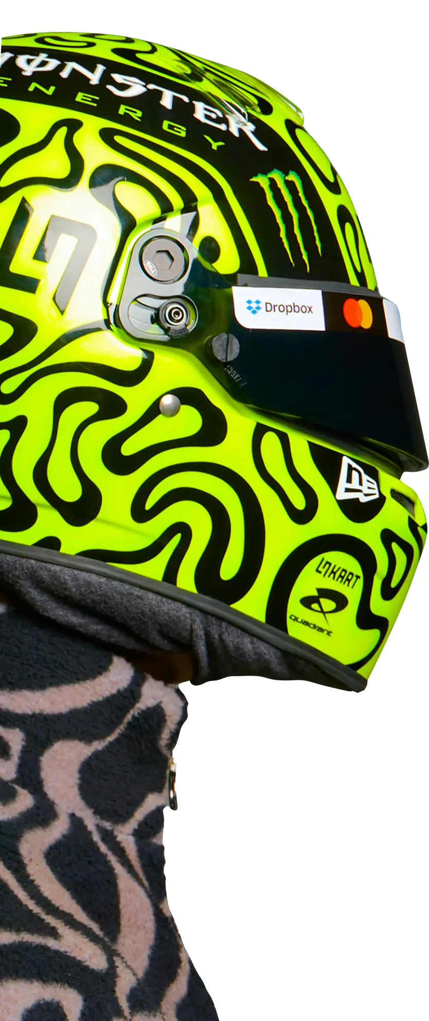 Lando Norris wearing a lime helmet, side profile