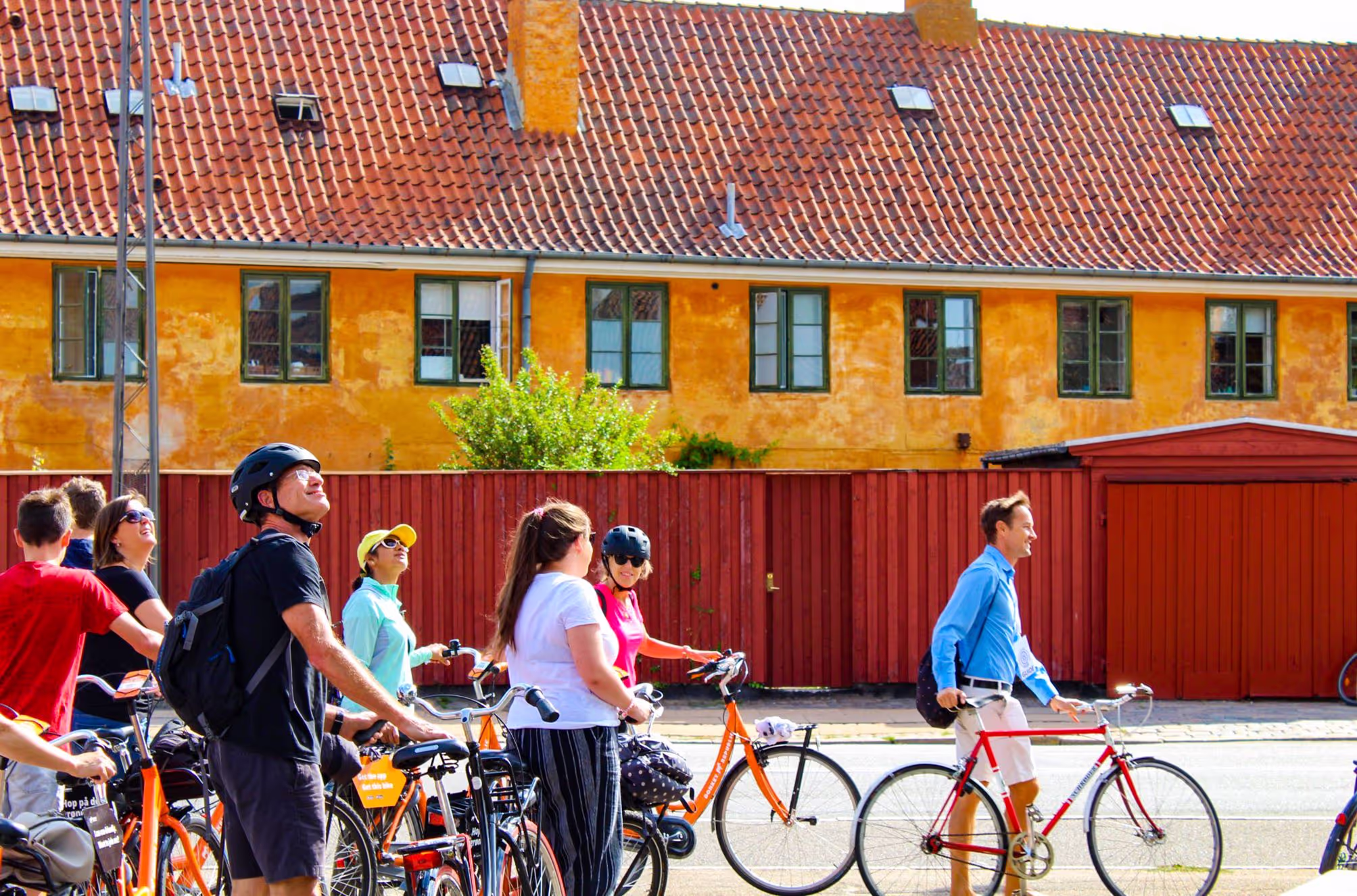 A group of people riding bikes down a street.