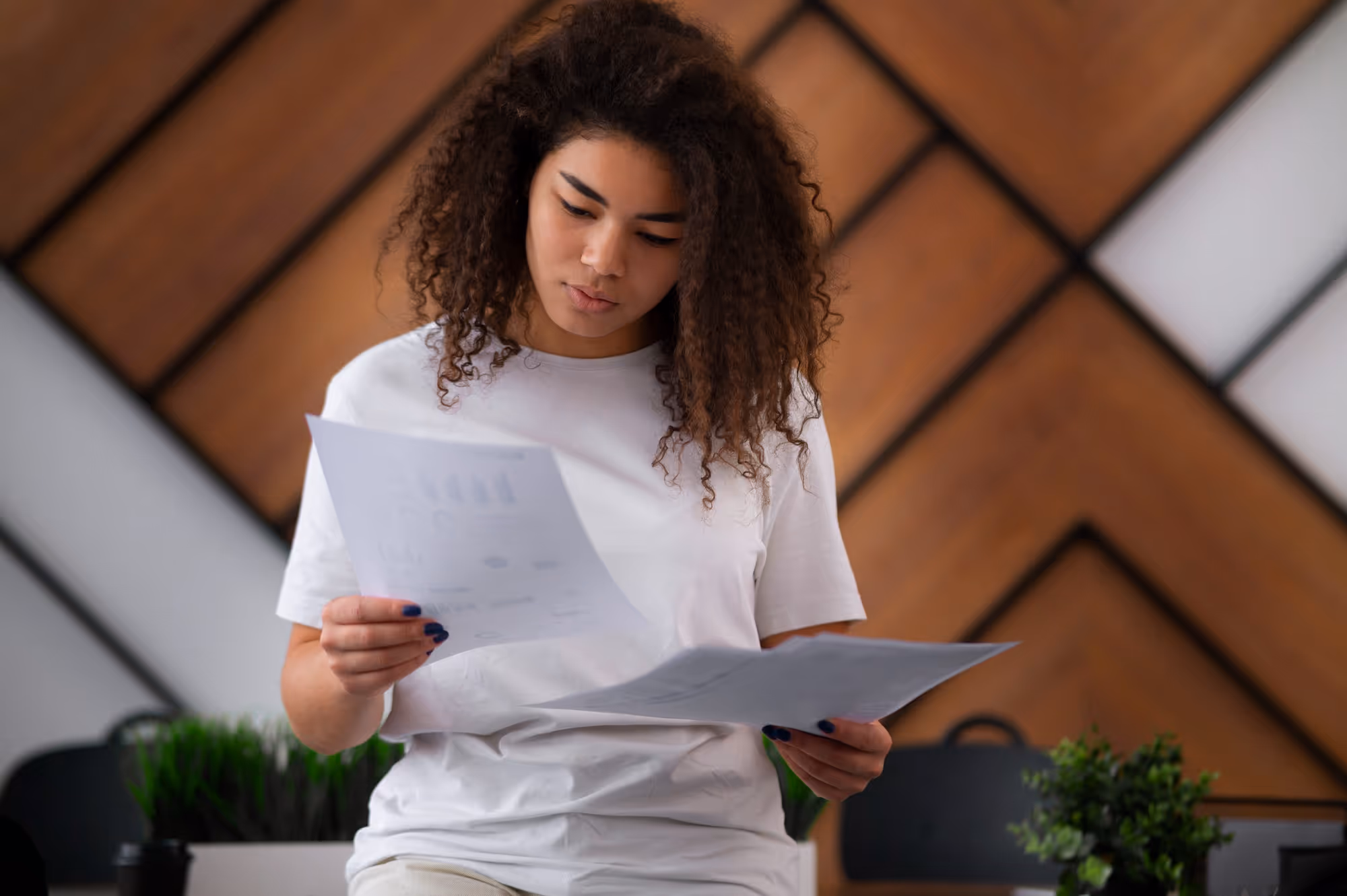 woman reading documents - Payroll Solutions