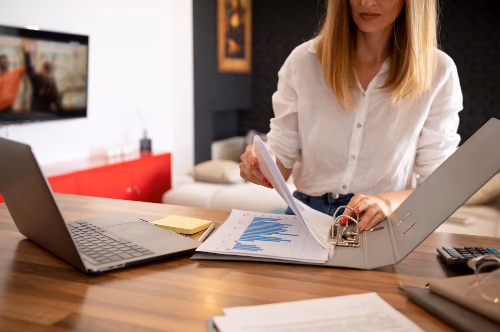 woman arranging a file - Outsourced Payroll Services