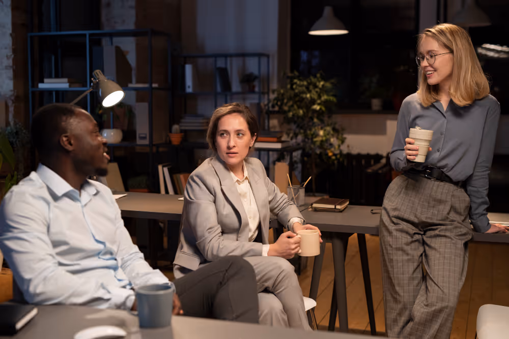 employees talking - Payroll Outsourcing Costs