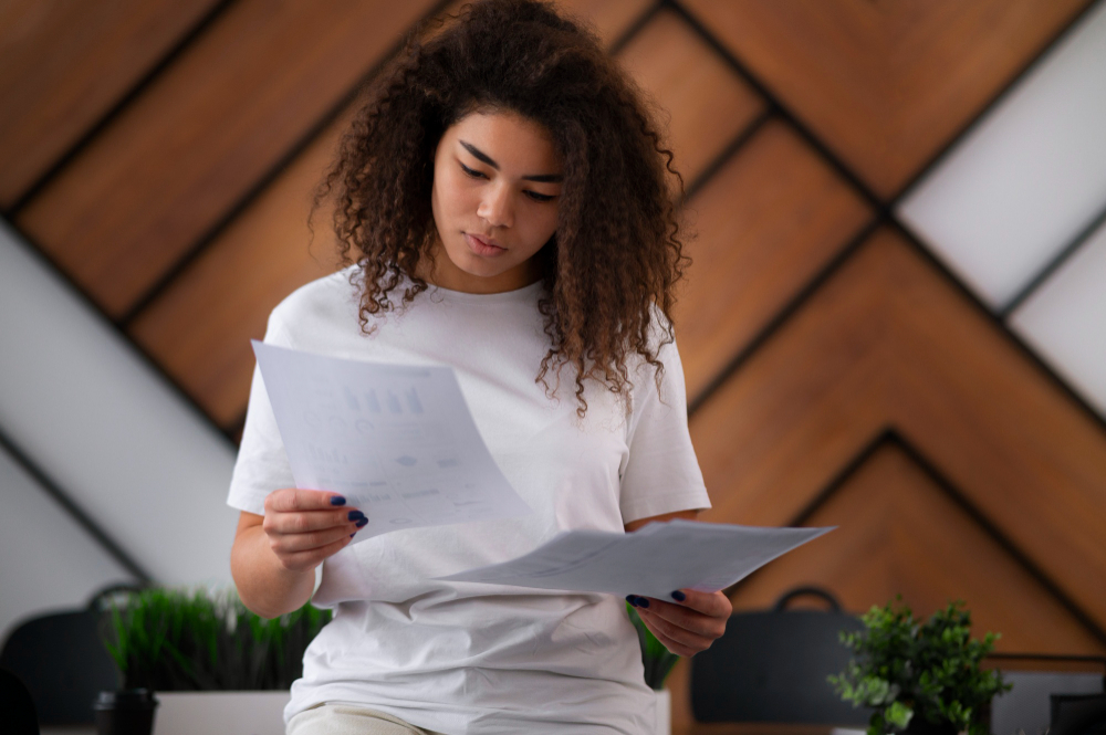 woman holding papers - UAE Labour Law Termination