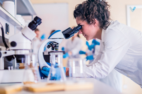 Woman scientist looking through a microscope.