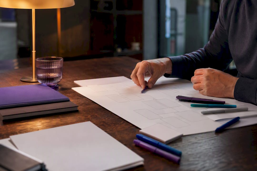 Hands organizing cash flow planning map on desk