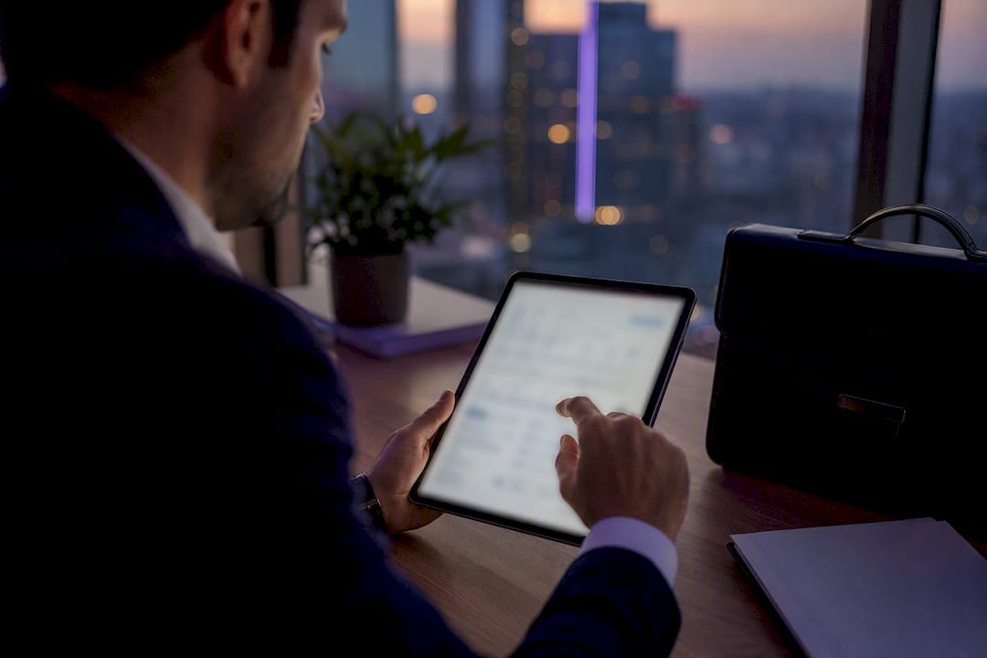 Hands using tablet tax deduction calculator