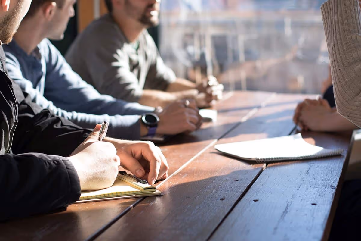 Informal meeting and discussion; rewards data concept|Platform dashboard open in laptop screen|Three women seated around conference table with laptops open