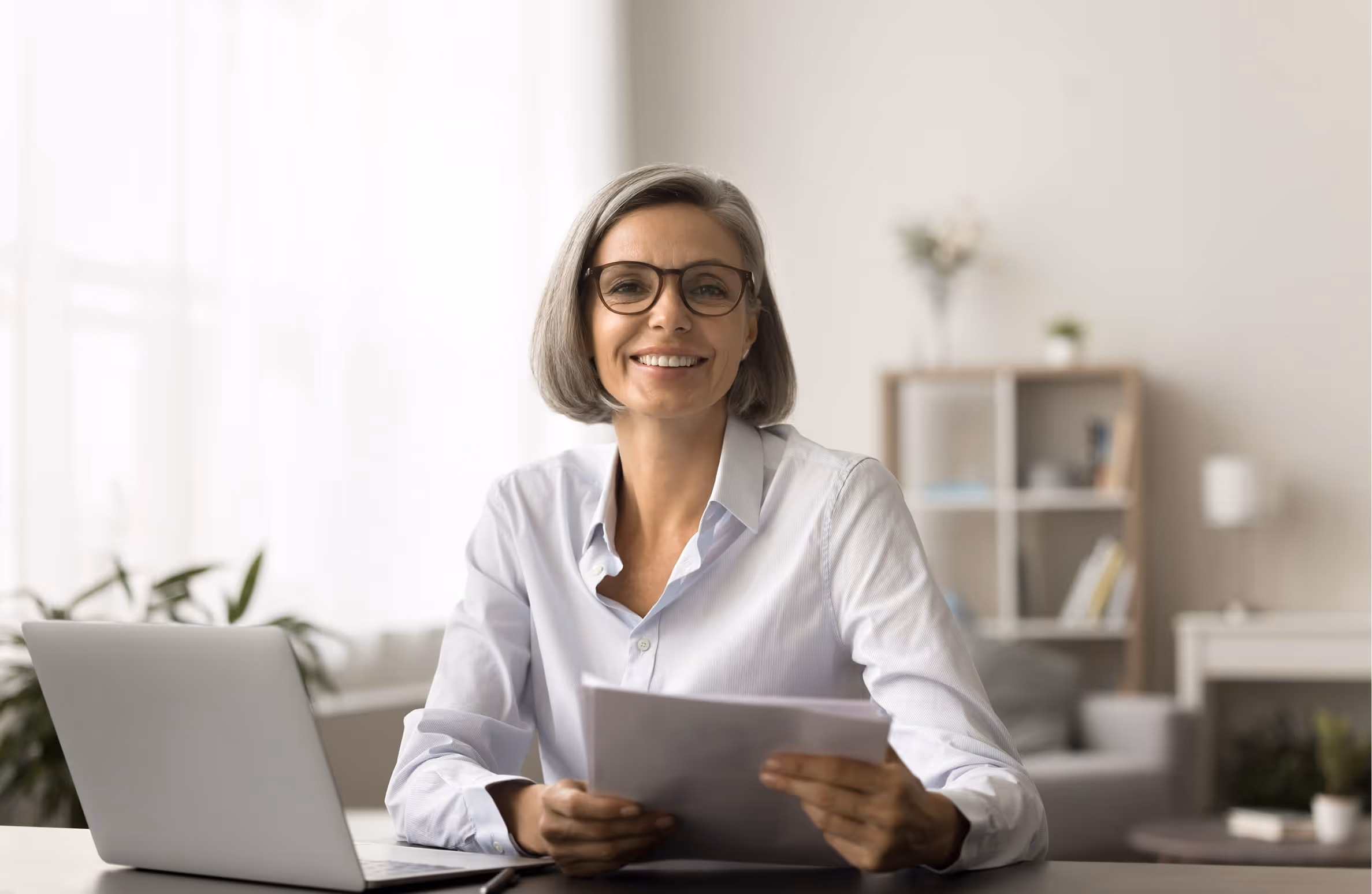 A woman sitting in front of a laptop computer.
