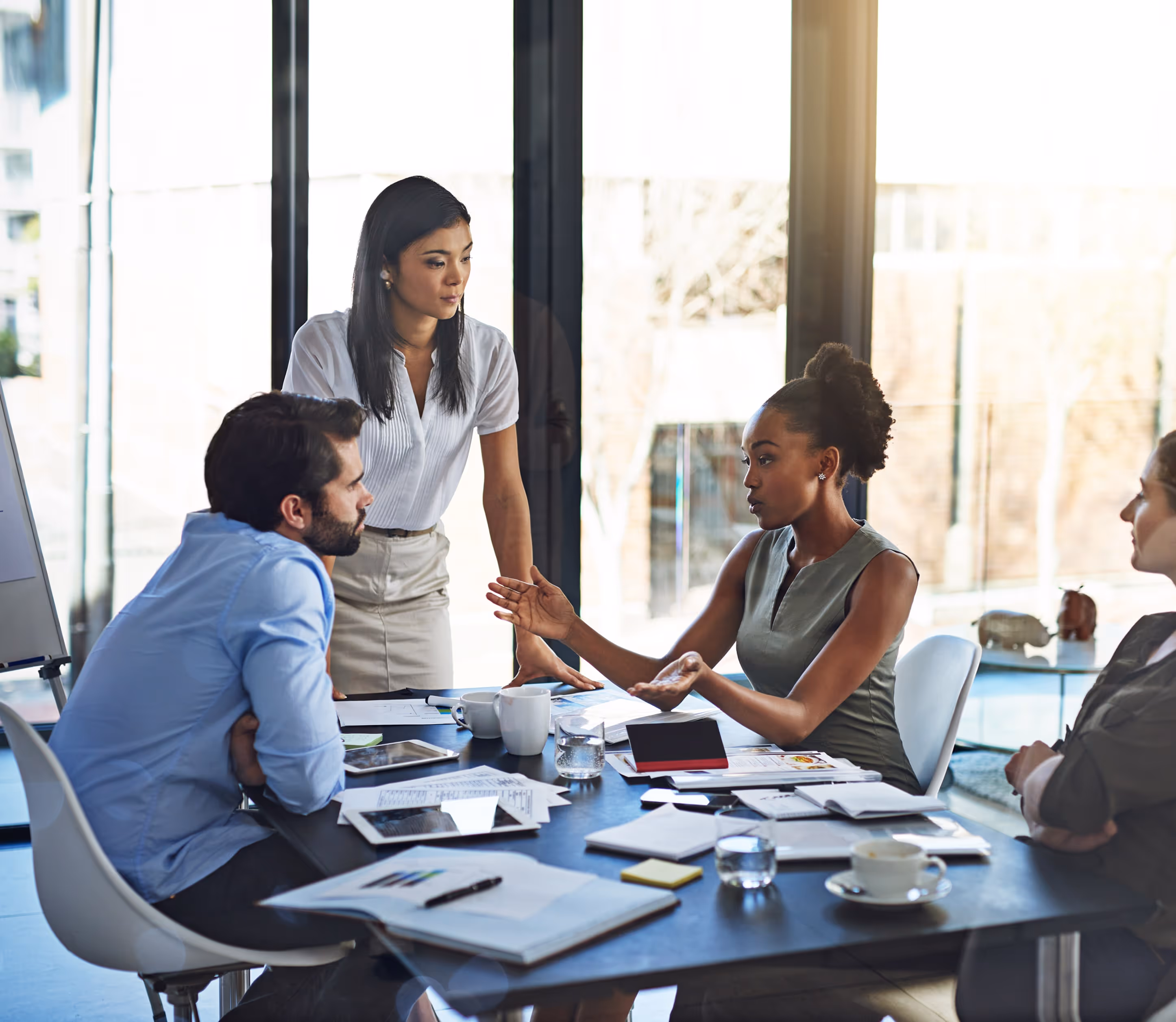 A group of people sitting around a conference table.