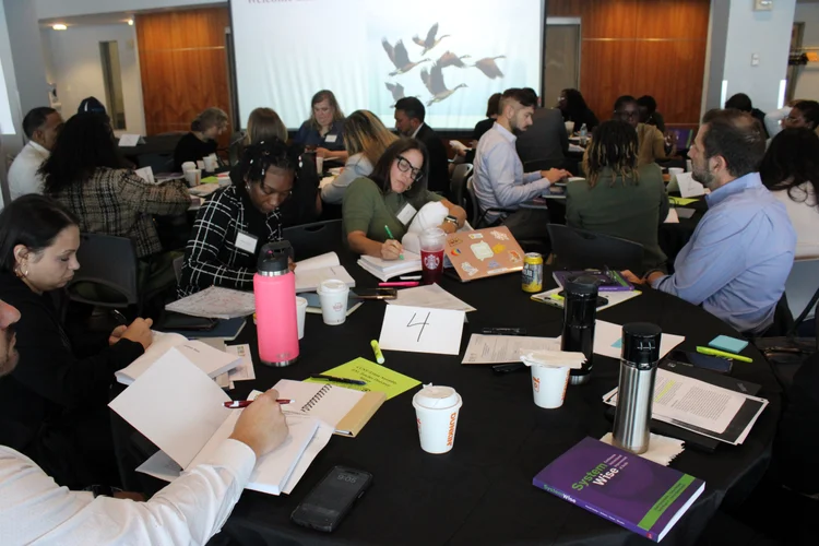 Educators collaborating at tables during a professional development workshop