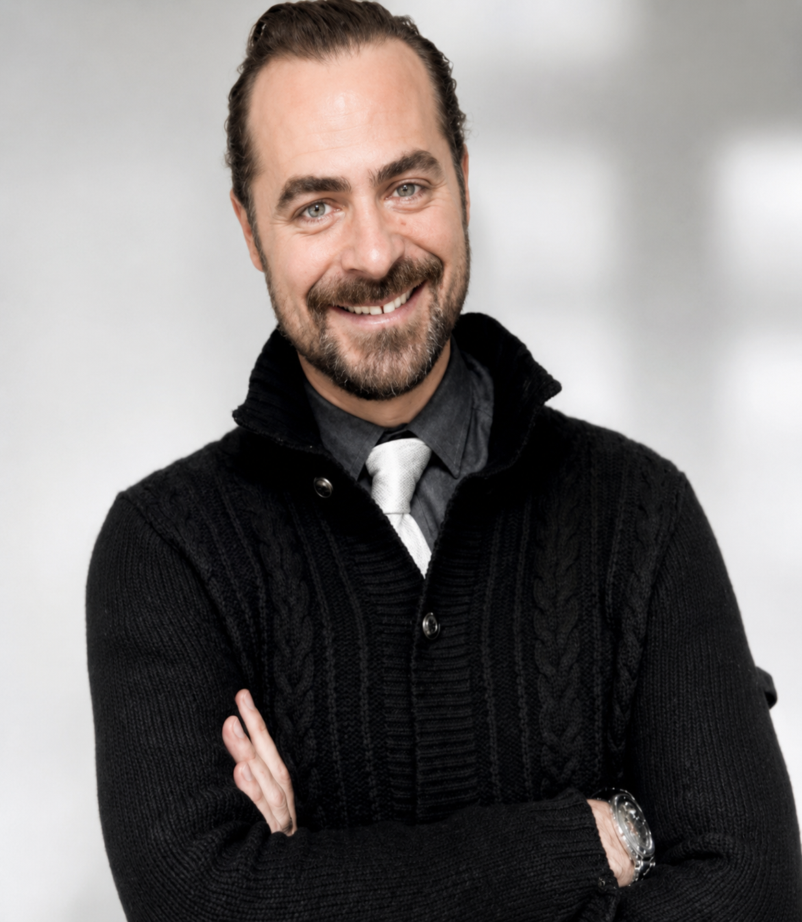 Luke Janka smiling with arms crossed in professional headshot