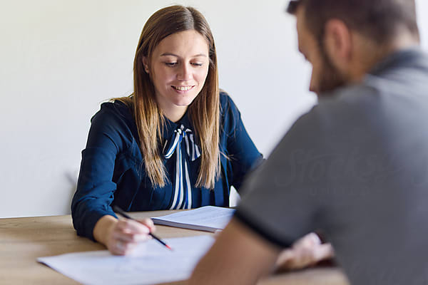 Team meeting in multifamily office discussing digital adoption and rent collection optimization across multiple properties