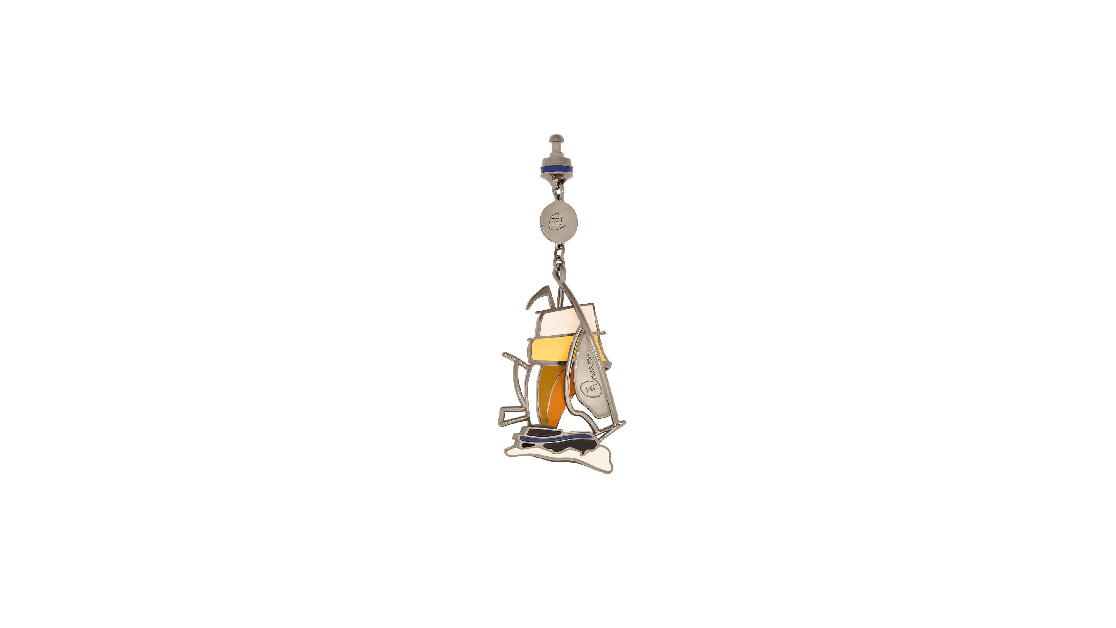 Metallic pendant of a sailboat on a white background
