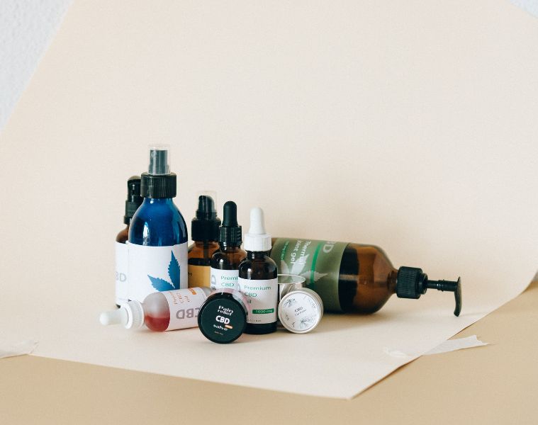 Assortment of CBD products on a light cream backdrop