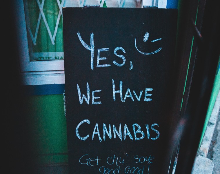 Blackboard sign with chalk writing saying 'Yes, we have cannabis'