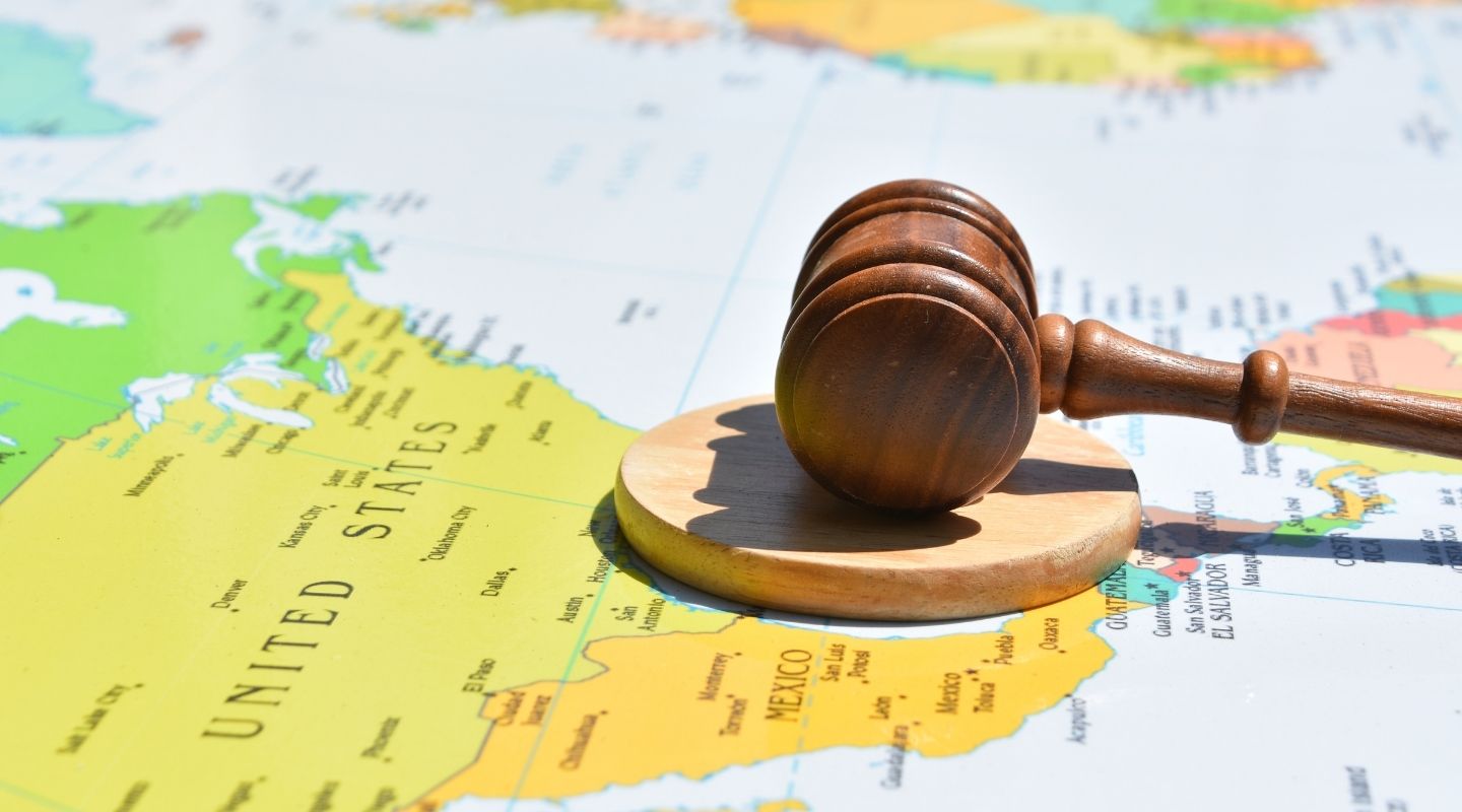 Gavel and block resting on a map showing the United States and Mexico