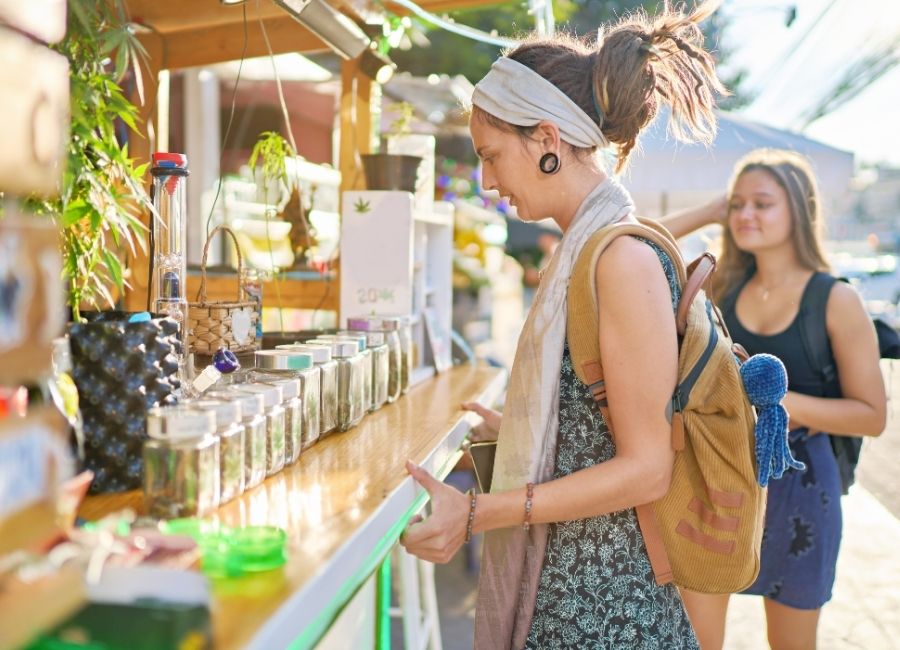 Two female tourists shopping for legal cannabis at a cannabis pop-up shop in Thailand