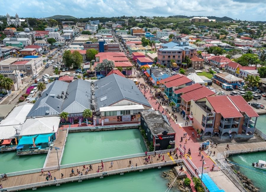 Aerial view of crowds on a pier with waterfront shops in St. Johns, Antigua and Barbuda 