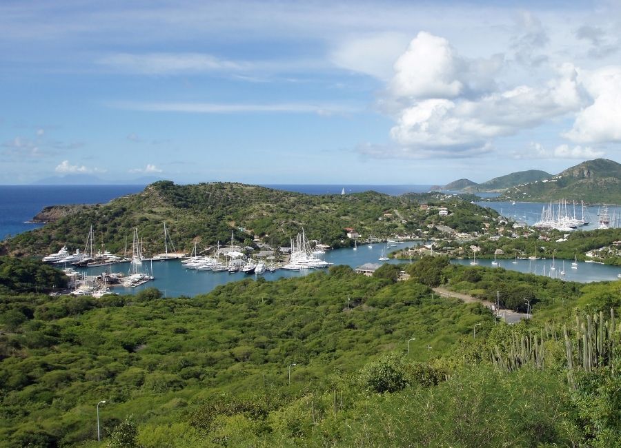 Coastal landscape at the entrance of English Harbour, Antigua, highlighting cliffs, sea, and natural vegetation