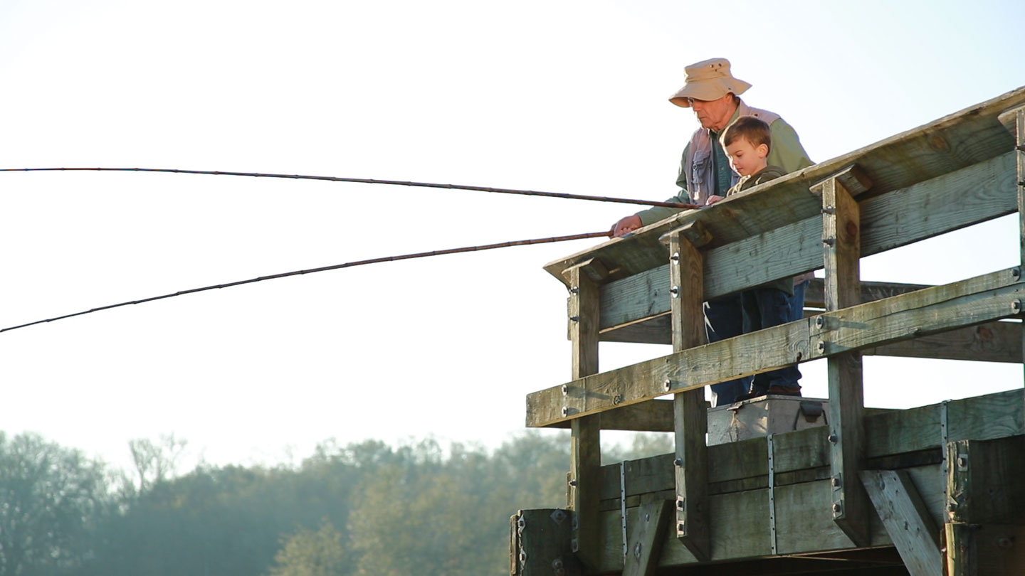 Grandfather and grandson fishing
