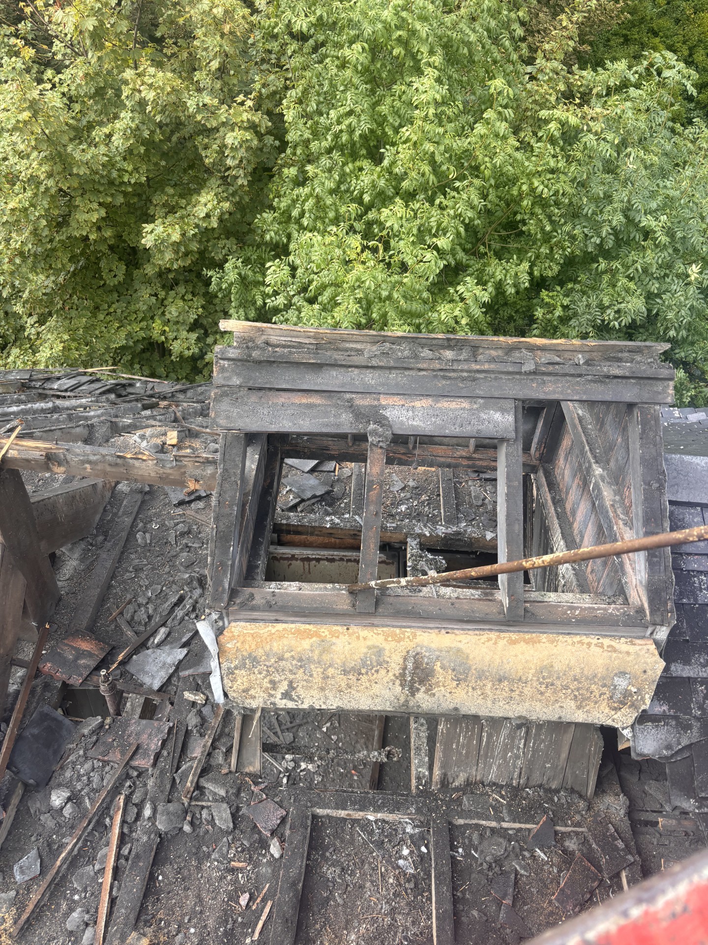 Close view of the fire-damaged high-level roof structure at Falcon Works from the man basket