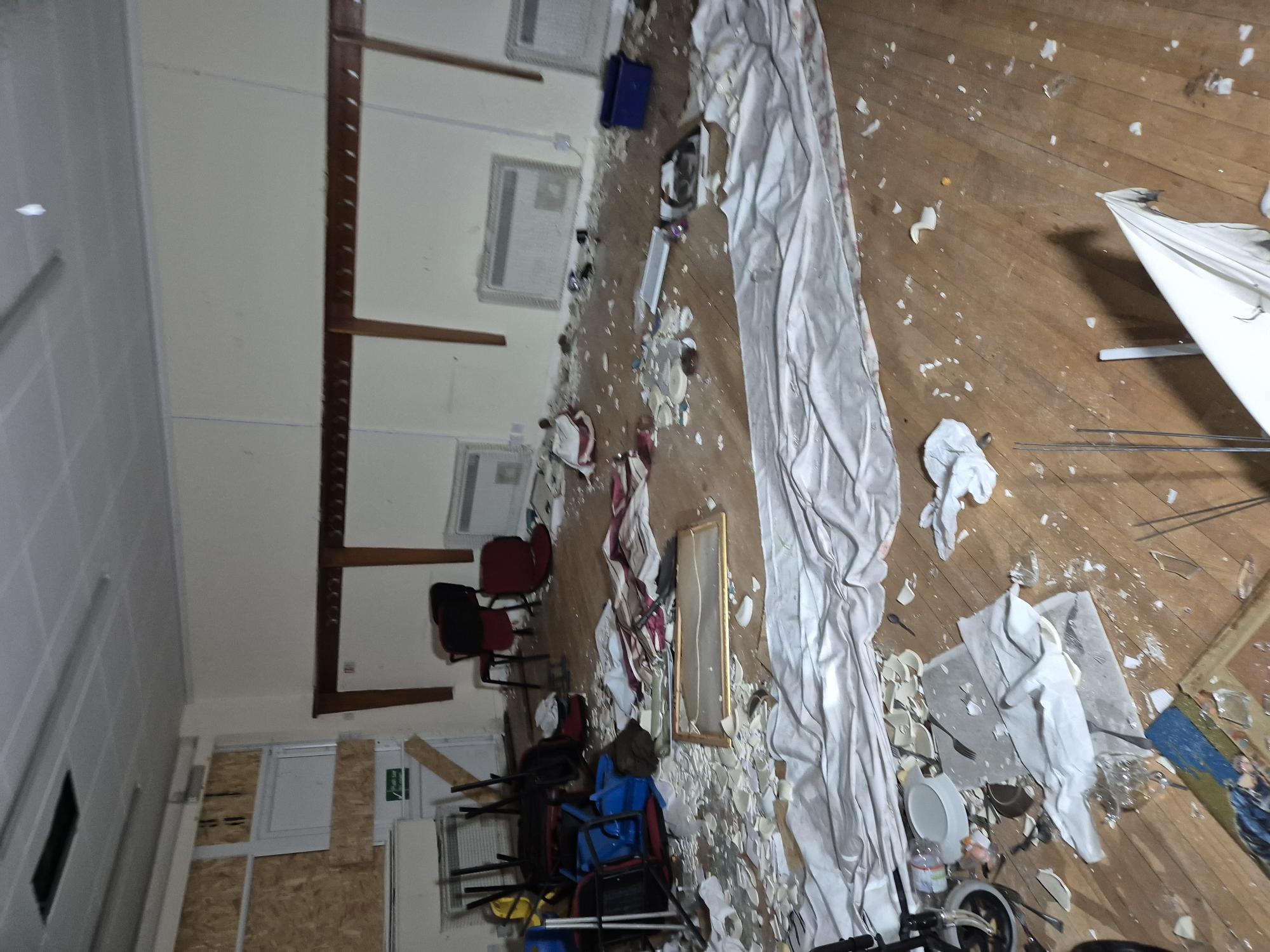 Asbestos debris and contaminated items across the church hall floor