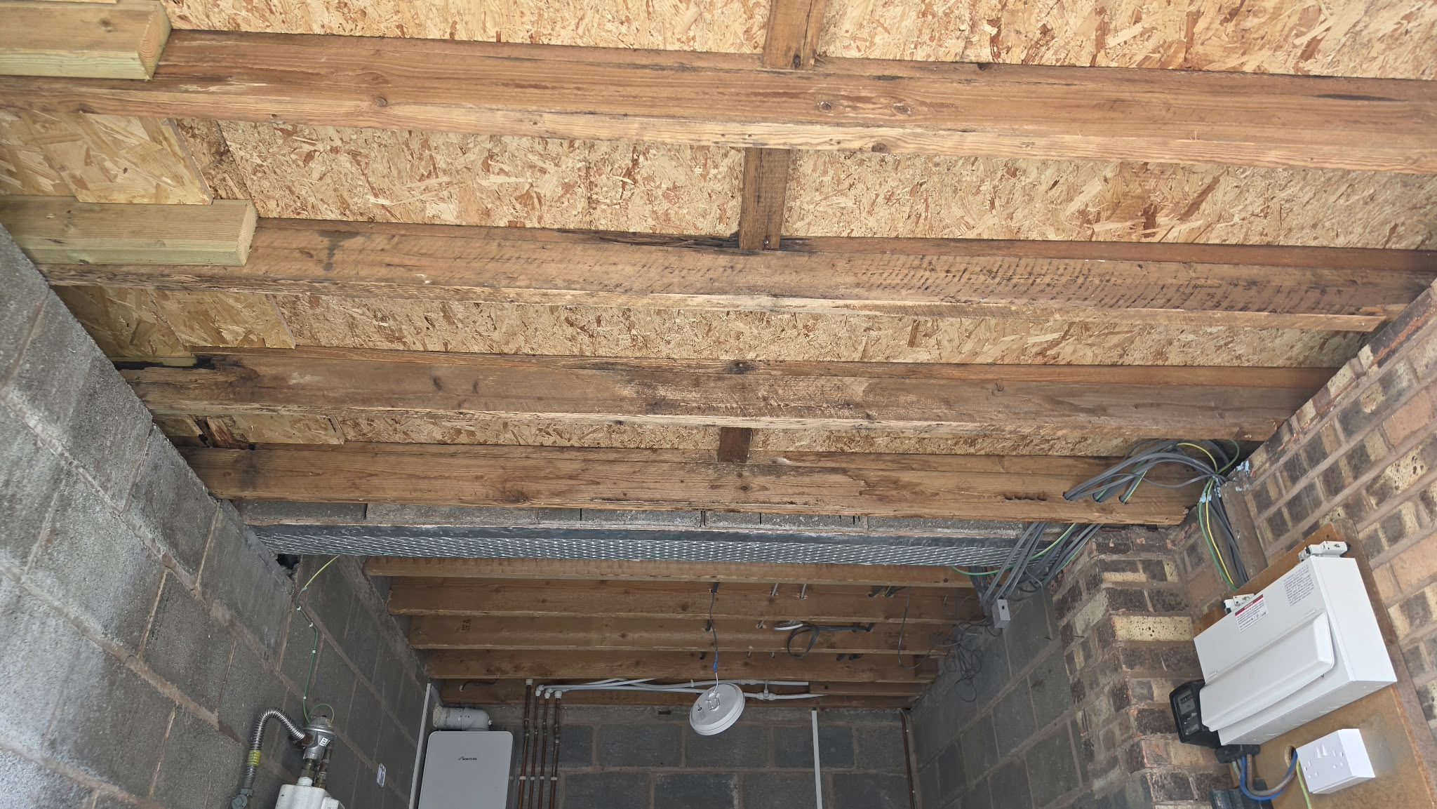 Garage ceiling joists exposed after licensed removal of AIB ceiling panels
