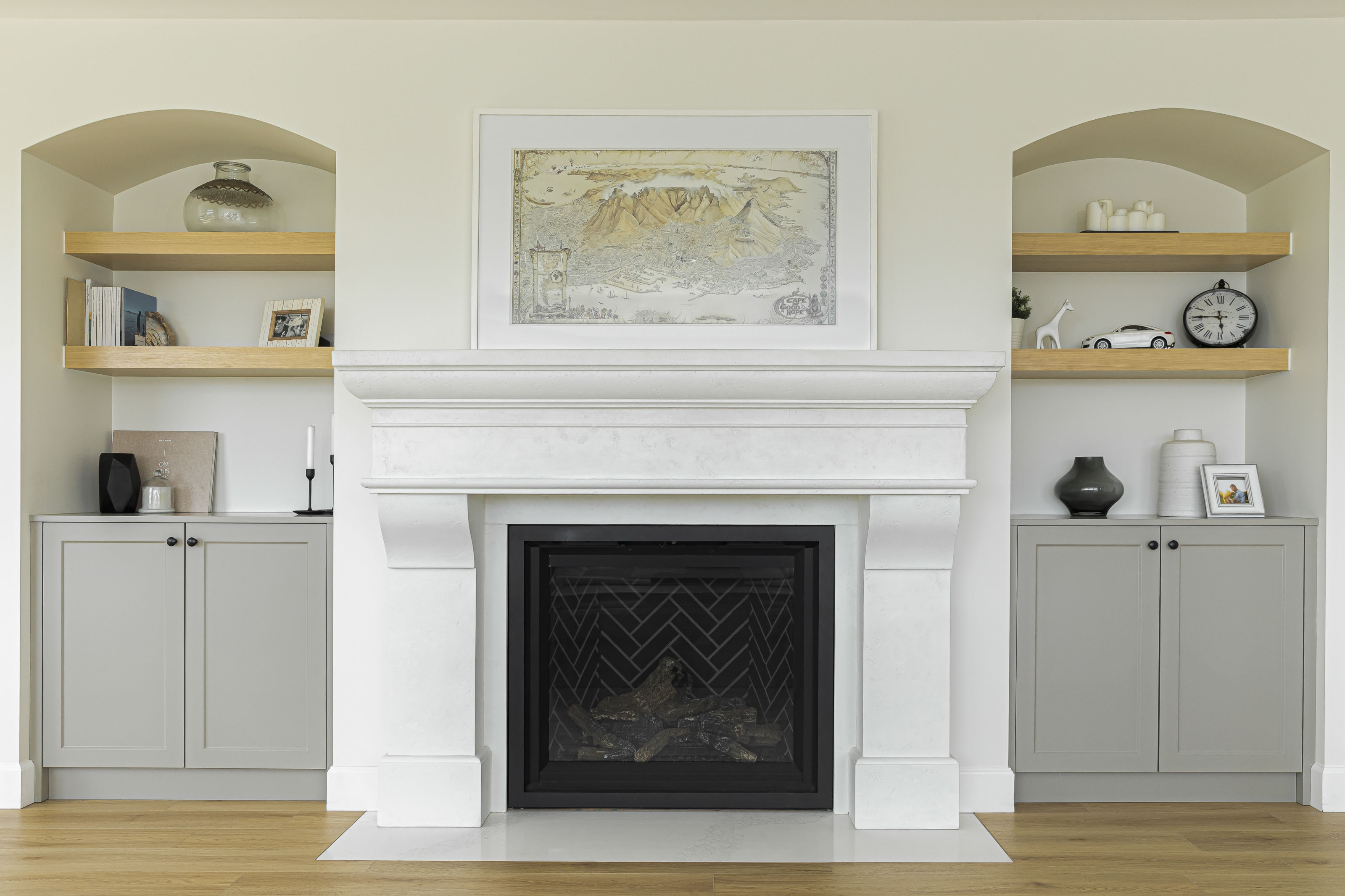 Symmetrical fireplace design with built-in cabinetry and shelving in a thoughtfully renovated Victoria, BC home.