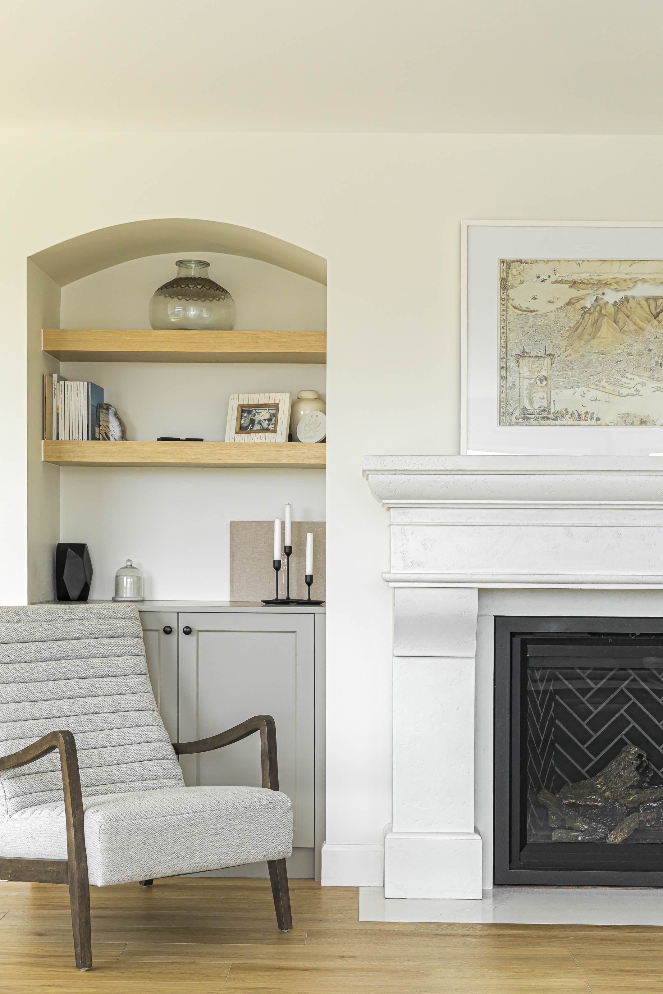 Symmetrical fireplace design with built-in cabinetry and shelving in a thoughtfully renovated Victoria, BC home.