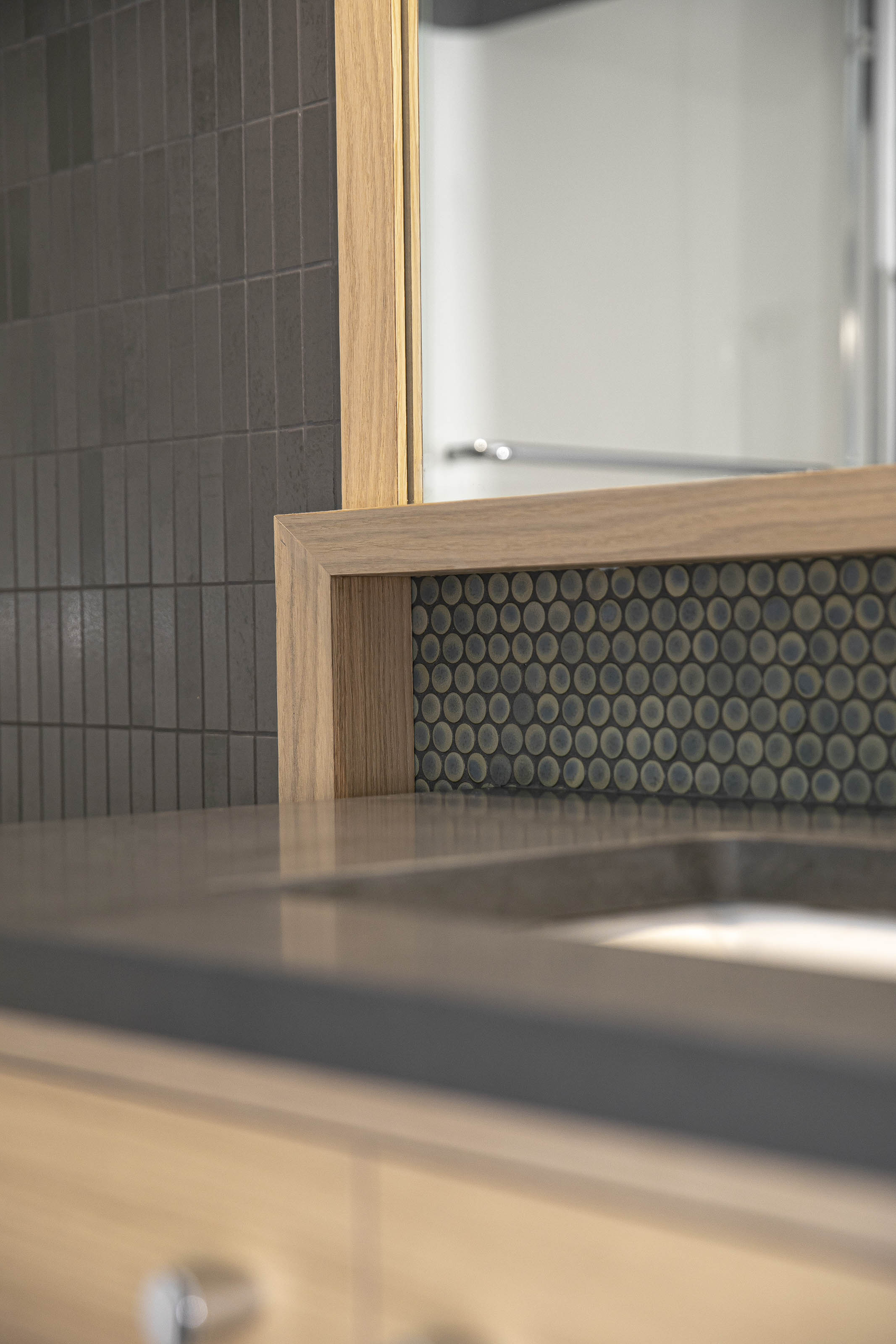 Detail of quartz backsplash and open shelf storage integrated with green kitchen cabinetry, part of a Victoria, BC kitchen remodel by Outlook Project Management