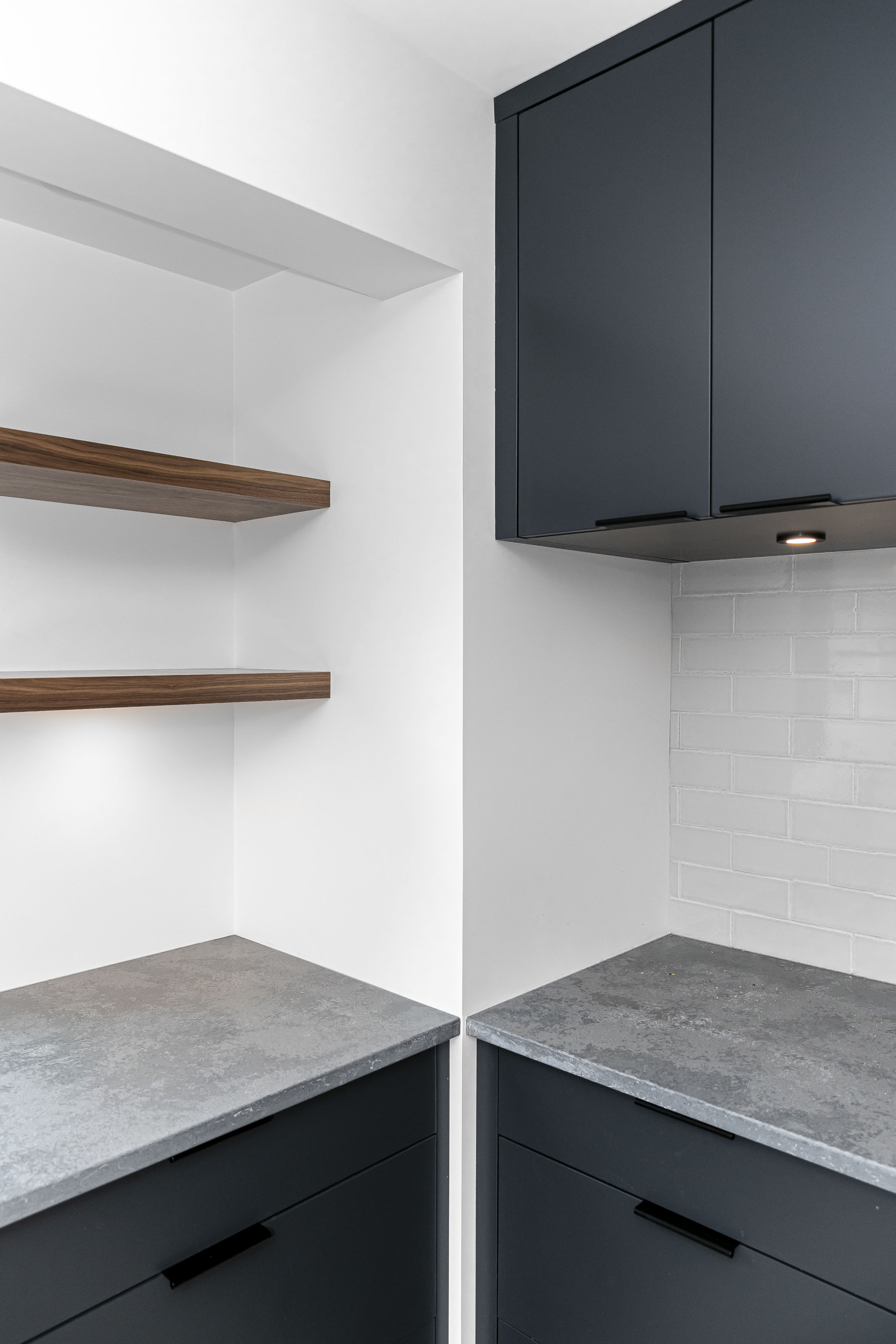 Close-up of corner kitchen countertops and matte black cabinetry from the Warder kitchen renovation project in Victoria BC by Outlook Project Management