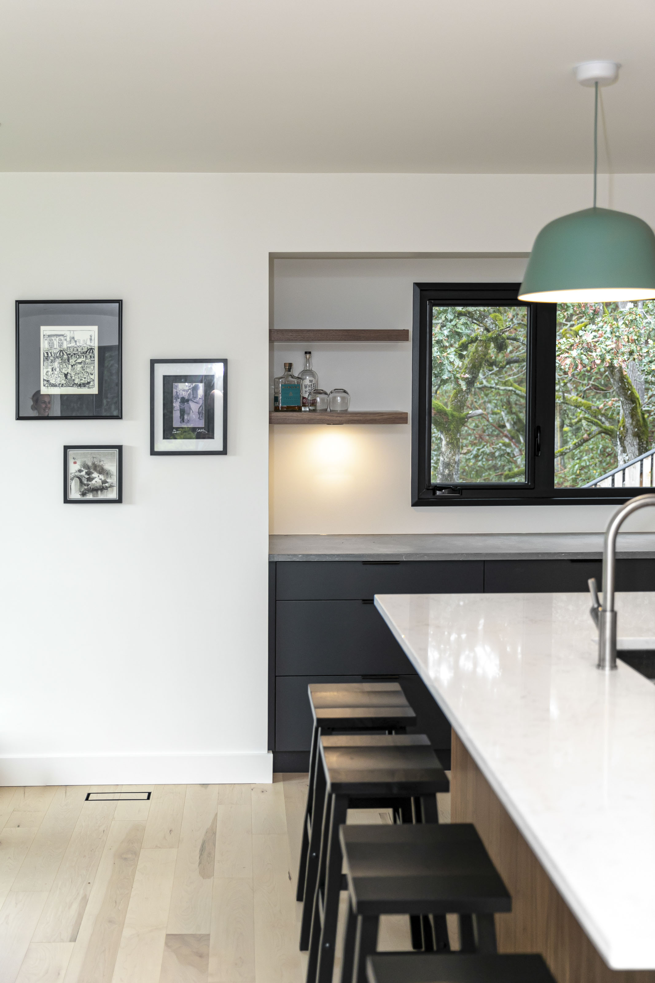 Bar nook with floating wood shelves and black window framing in the Warder kitchen renovation by Outlook Project Management, Victoria BC