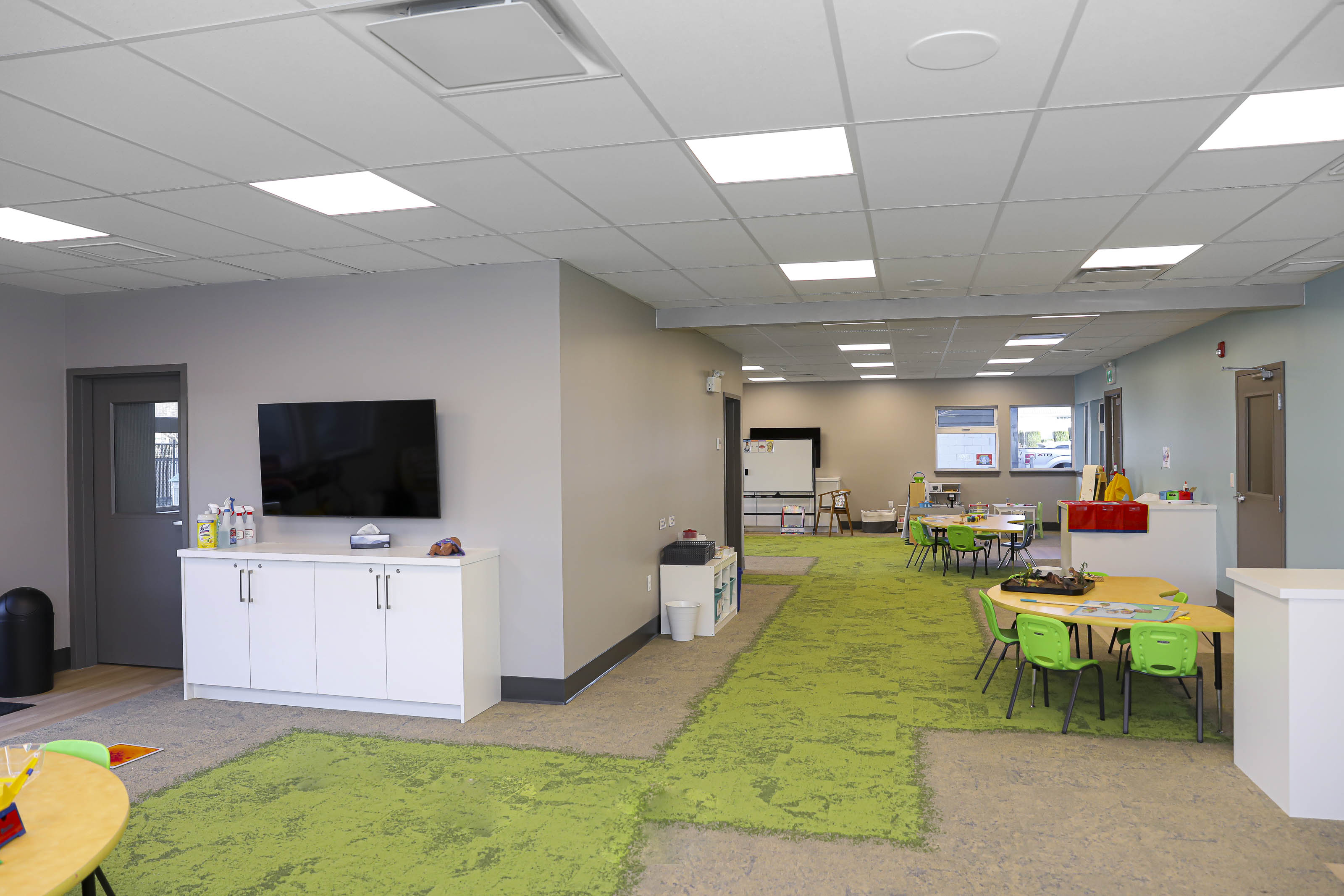 Open-concept childcare facility Victoria BC - Coastline church renovation by Outlook Project Management with multiple activity zones, modern furniture, and integrated storage solutions