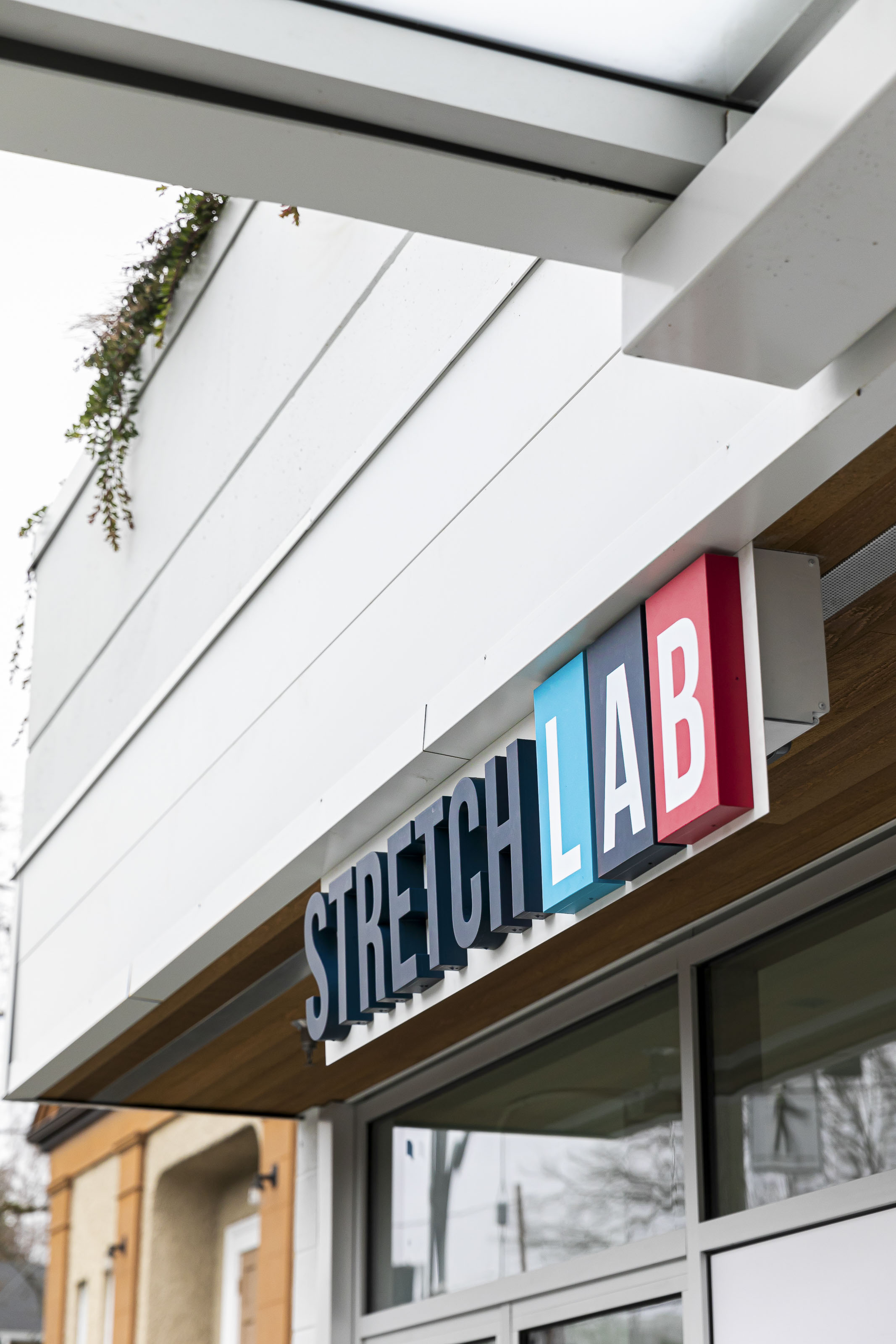Commercial exterior signage installation Victoria BC - Stretch Lab franchise construction by Outlook Project Management with modern building facade and professional business signage